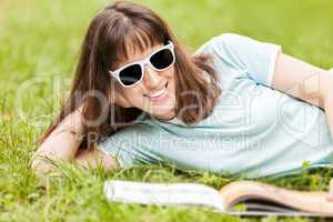 Beauty smiling woman reading book outdoor