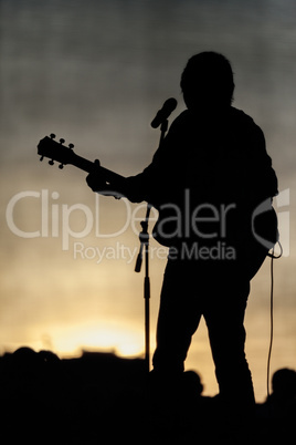 Popular music concert stage and musician silhouette