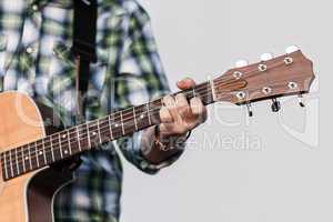 Human hand holding guitar music instrument