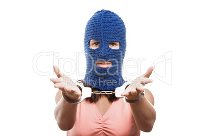 Woman in balaclava showing handcuffs on hands