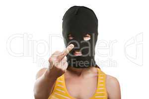 Woman in balaclava showing middle finger hand gesture