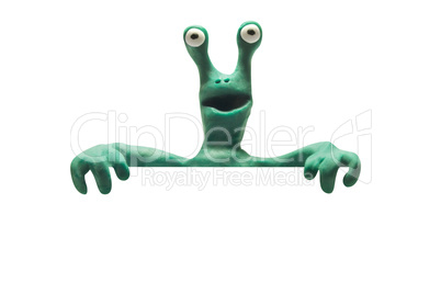 clay alien from behind blank banner isolated with clipping path