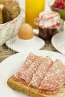frisches frühstück mit toast, salami, ei und saft auf einem Ti