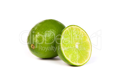 One whole lime and one half lime on white