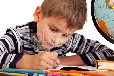 Cute schoolboy is writting