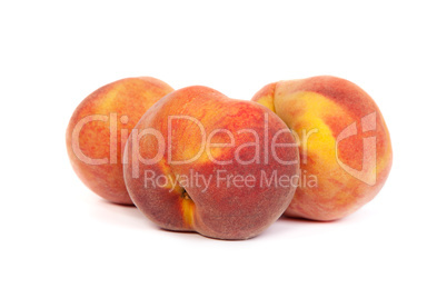 Three tasty juicy peaches on a white background