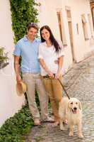 Modern couple with dog in romantic city