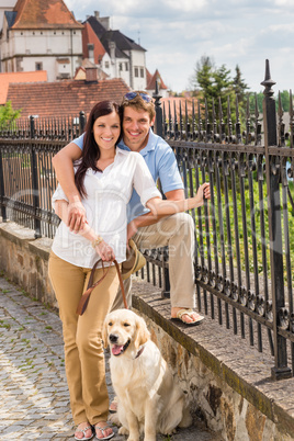 Young couple with dog at historical town