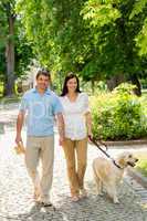 Young couple in love walking dog park