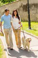 Young couple in love walking dog park