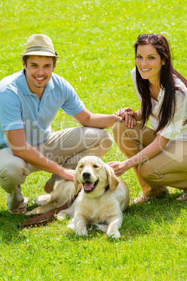 Young happy couple with Labrador dog