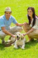 Young happy couple with Labrador dog