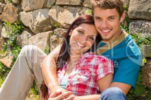 Young couple in love leaning against wall