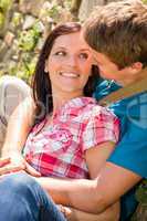 Young loving couple outdoors look each other