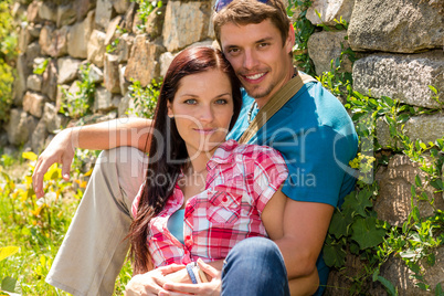Young couple in love leaning against wall