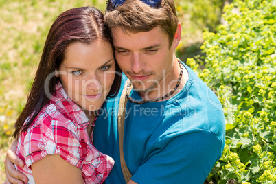 Happy affectionate young couple hugging in park