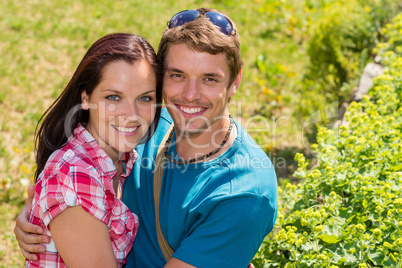 Young happy couple embracing in sunny park
