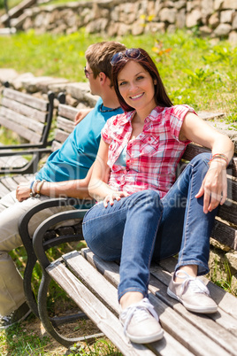 Young couple sitting on bench in park