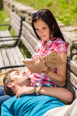 Young happy couple relax on bench park