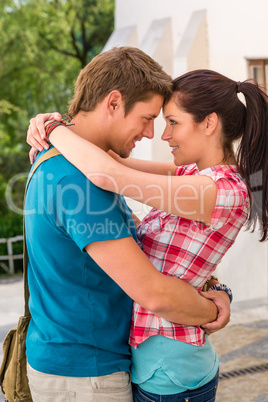 Young happy affectionate couple flirting outdoors