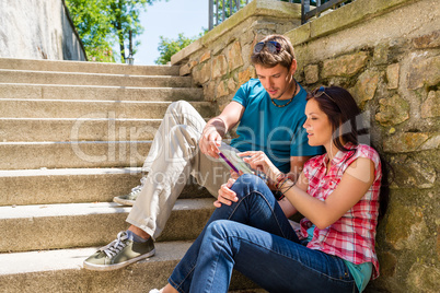 Young couple looking city map sunny day