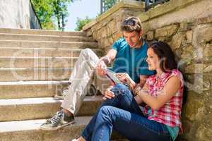 Young couple looking city map sunny day