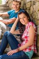 Young couple relax on stone stairs