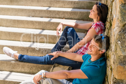 Young happy couple flirting on the stairs