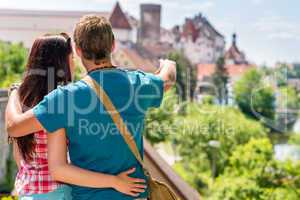 Young man showing woman the castle architecture