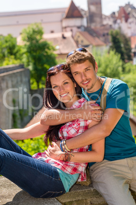 Young happy couple embracing on balcony smiling