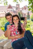 Happy young couple photographing themselves