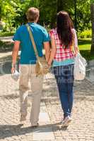 Couple holding hands walking in the park