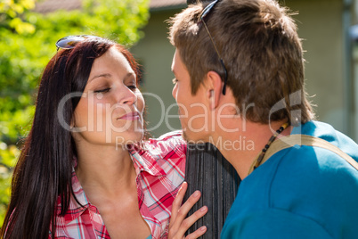 Young couple about to kiss in park