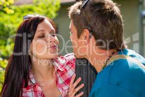 Young couple about to kiss in park