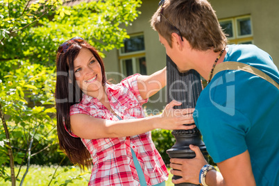 Young playful couple smiling in sunny park