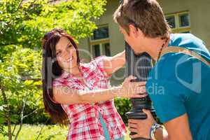Young playful couple smiling in sunny park