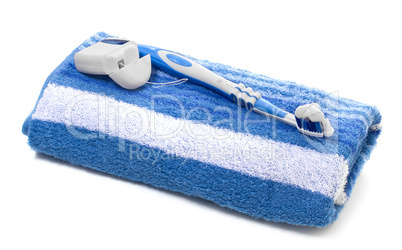 dental floss and toothbrush, towel on a white background