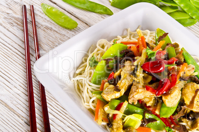 Noodles with pork and vegetables in plum sauce