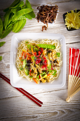 Noodles with pork and vegetables in plum sauce