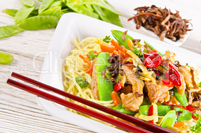 Noodles with pork and vegetables in plum sauce