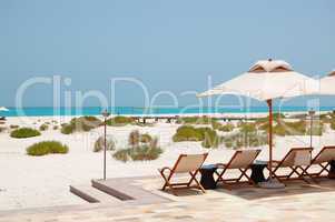 Sunbeds and umbrellas at the beach of luxury hotel, Abu Dhabi, U
