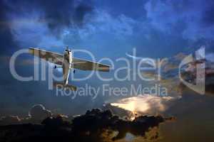 Small fixed wing plane against a stormy sky