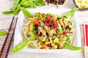 Noodles with pork and vegetables in plum sauce