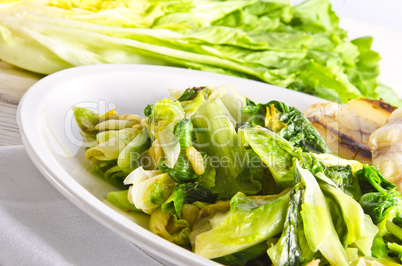 baked Romaine lettuce with garlic and pine cores