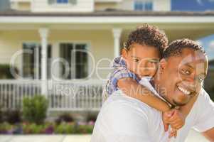 Mixed Race Father and Son In Front of House