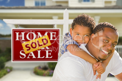 Mixed Race Father and Son In Front of Real Estate Sign and House