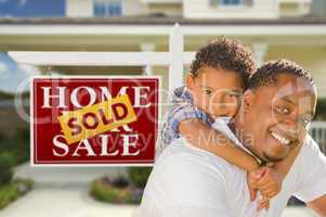 Mixed Race Father and Son In Front of Real Estate Sign and House