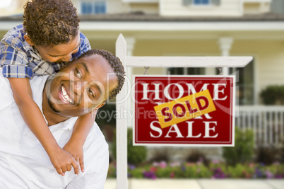 Mixed Race Father and Son In Front of Real Estate Sign and House