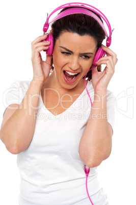 Brunette women enjoying rocking with loud music