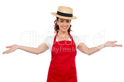 Pretty chef welcoming you with her arms stretched
